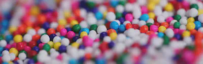Close up of tiny rainbow colored sugar candies.